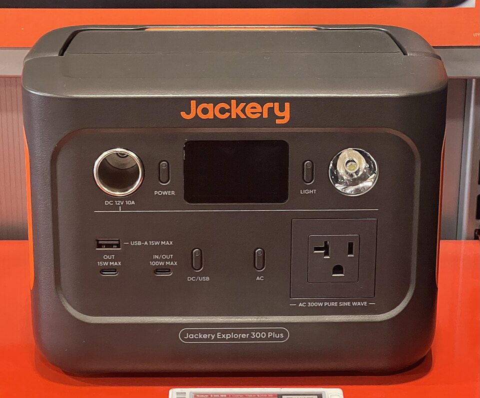 A dark gray Jackery Explorer 300 Plus power station with a display, USB ports and an AC outlet on the front, for storm prep in Cedar Rapids, IA